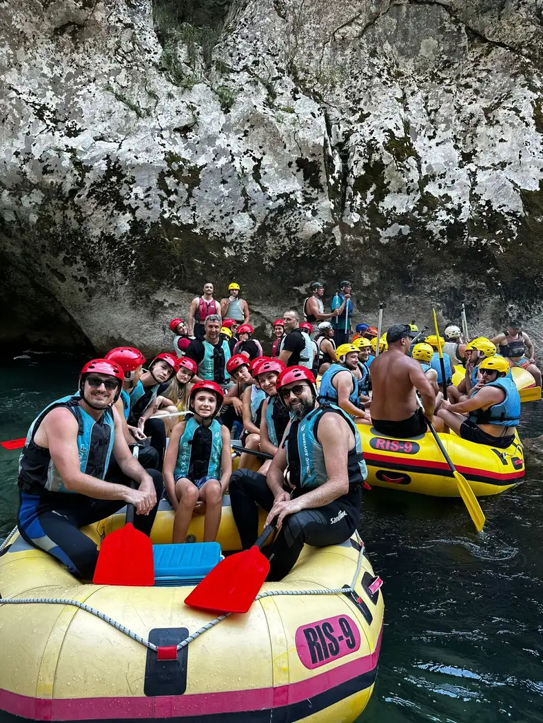 The Oratio team in helmets and life vests in a raft in the Neretva canyon
