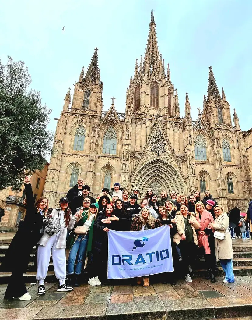 The team with its Oratio flag in front of Barcelona Cathedral